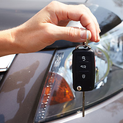 Hand with a car key.